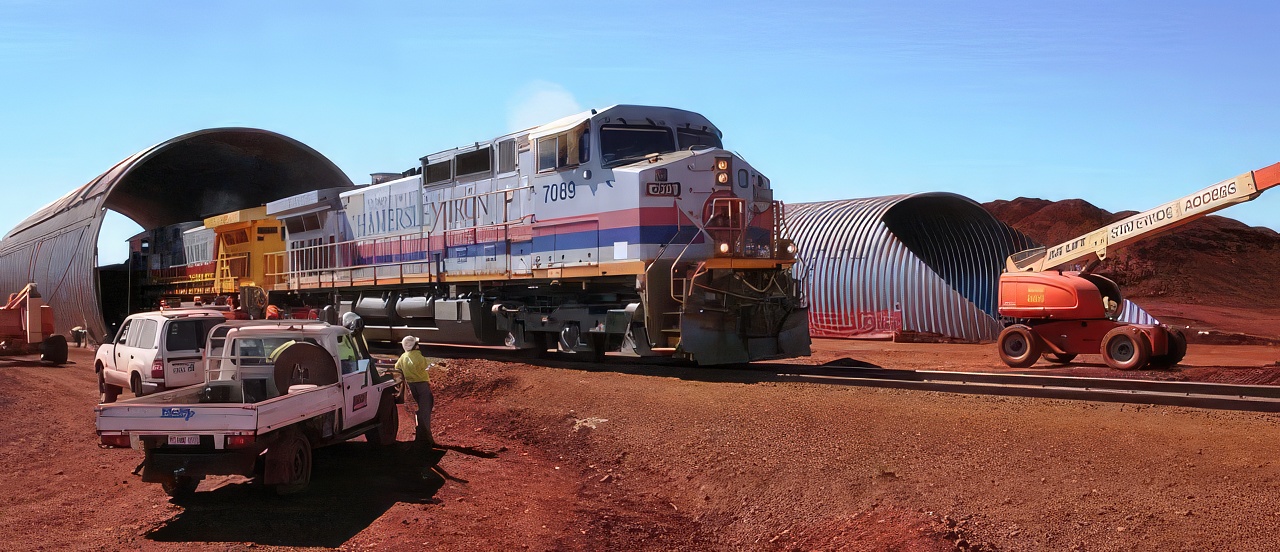 Ore train passing through haul road arch under construction